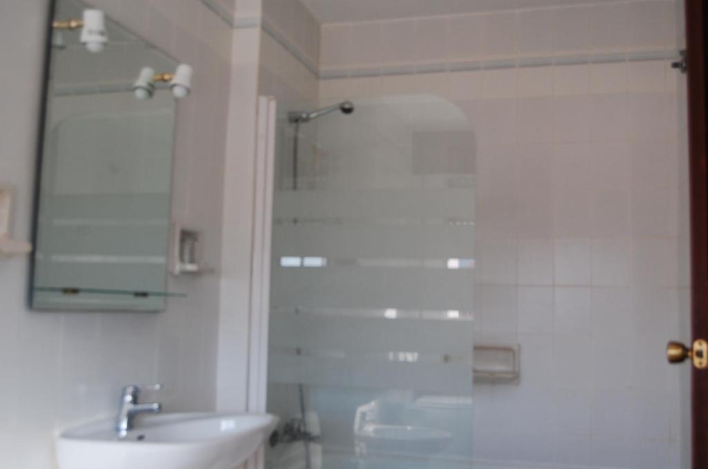 łazienka z umywalką i prysznicem z lustrem w obiekcie Hotel Marina Victoria w mieście Algeciras