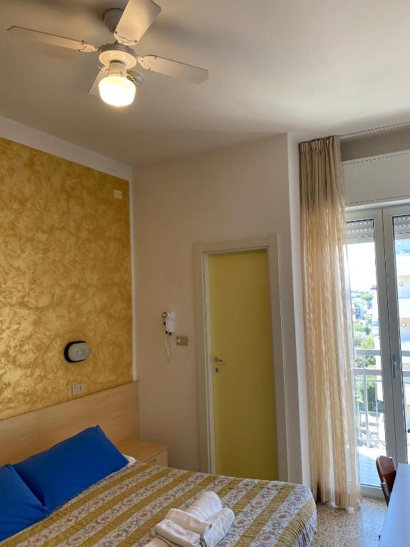Postel nebo postele na pokoji v ubytování Hotel Loretta