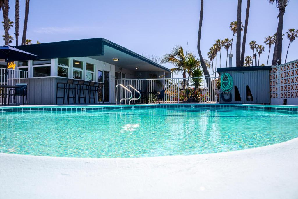 a large swimming pool in front of a house at Ocean Villa Inn in San Diego