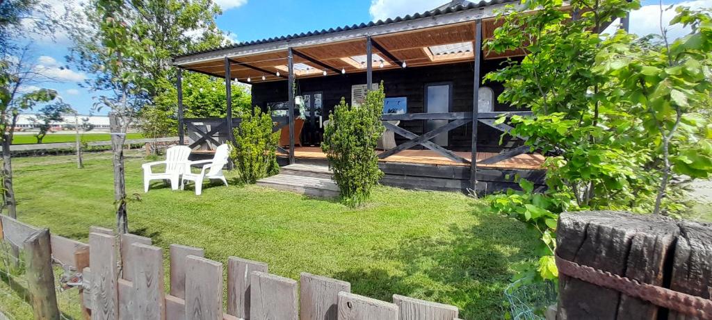 a house with a table and chairs in a yard at No Milk today in Scherpenzeel