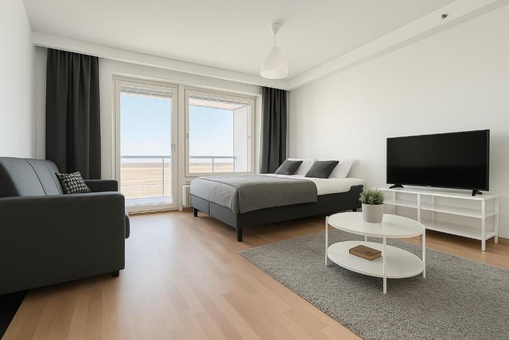 a white living room with a bed and a tv at City Home Finland Panorama Suite - New Luxury Suite with Own SAUNA, One Bedroom, Spacious Balcony with City Views and Great Location next to Nokia Arena in Tampere