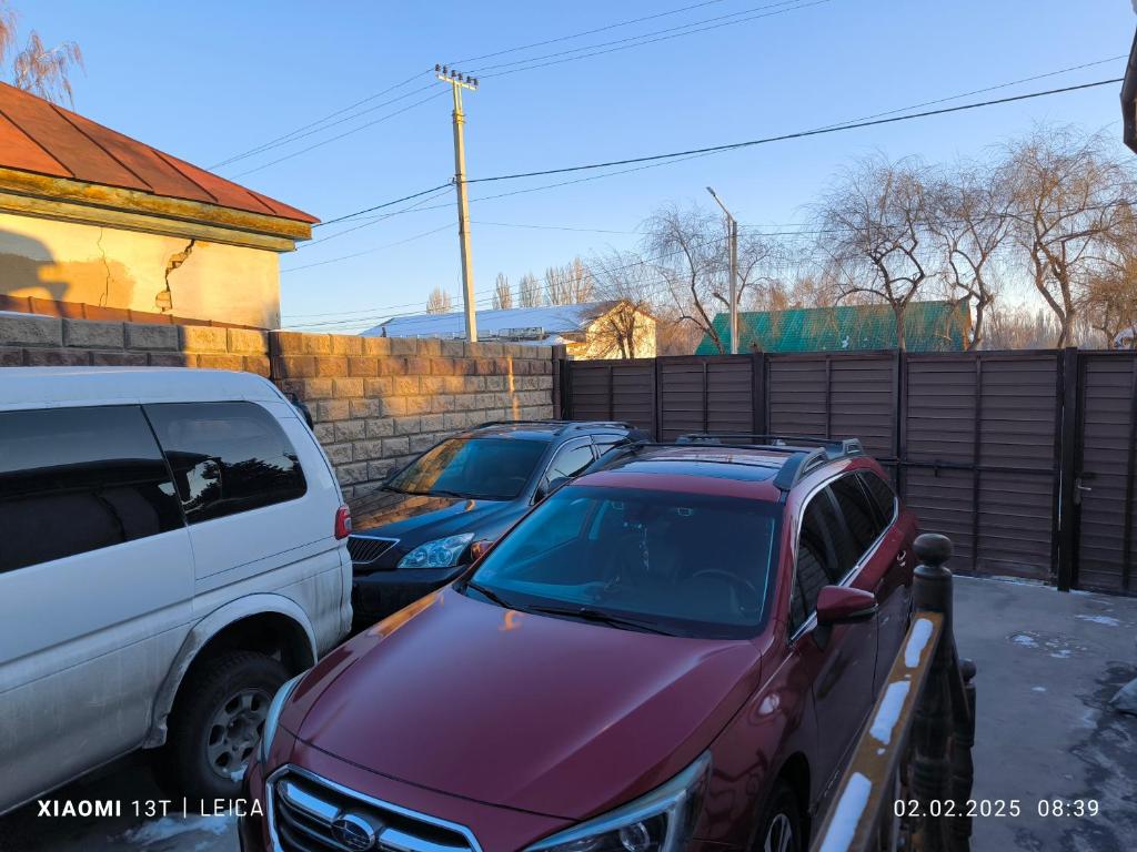a group of cars parked in a parking lot at Hadia guest House in Karakol