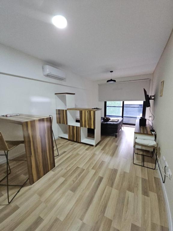 a living room with a table and a couch at Alquiler Temporario Rosario 24 in Rosario