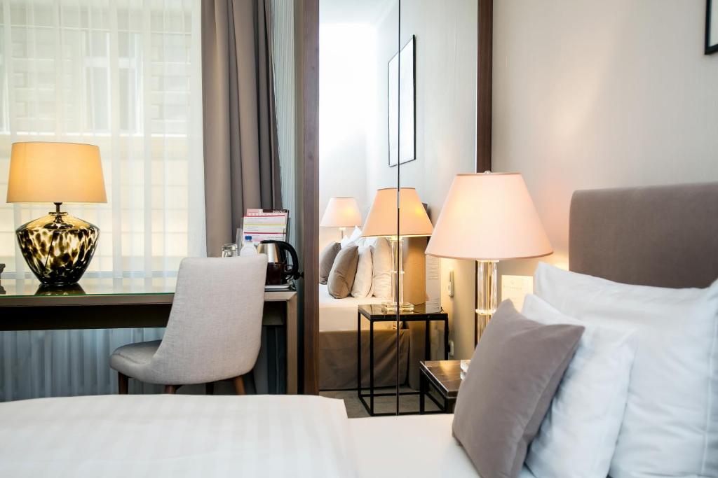Postel nebo postele na pokoji v ubytování Ambra Hotel