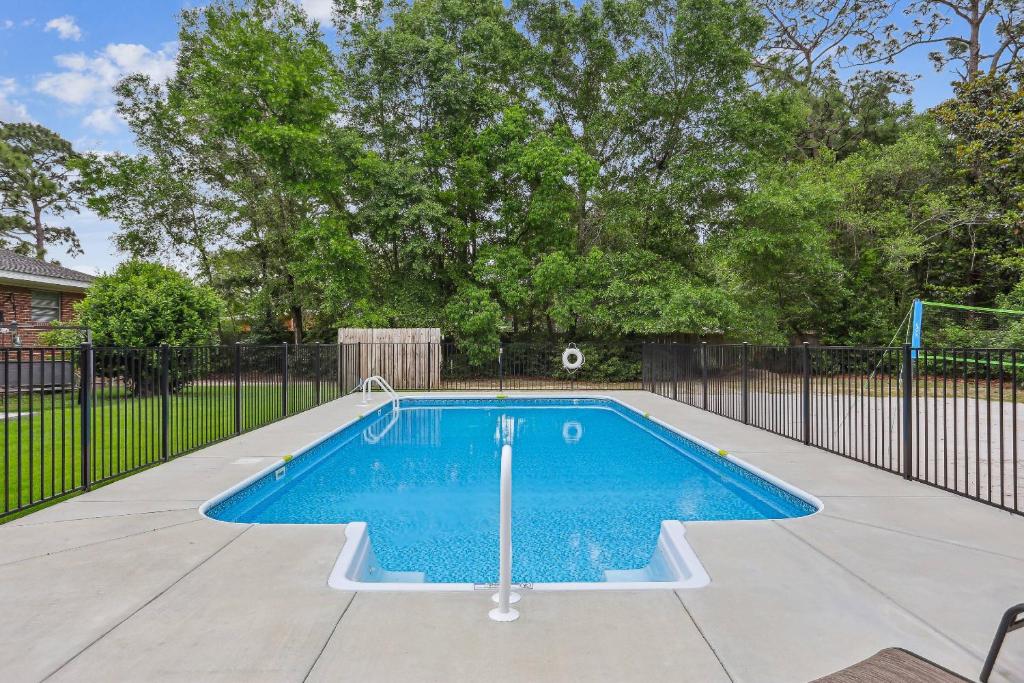 a swimming pool in a yard with a fence at 2967 Swan Lane in Pensacola