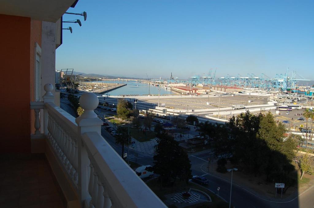 a balcony of a building with a view of a harbor at Hotel Marina Victoria in Algeciras