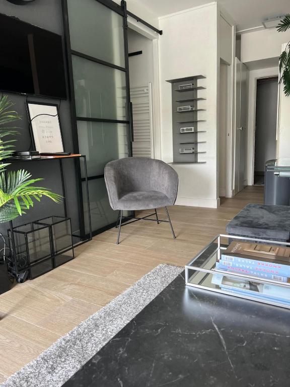 a living room with a couch and a chair at 2 bedroom apartment at Knokke-Heist, near Zeebrugge, overlooking the lake in Knokke-Heist