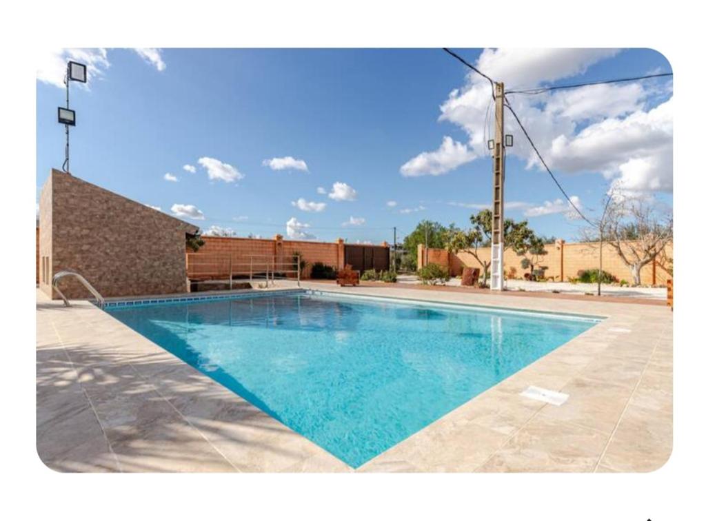 a swimming pool in the middle of a yard at Huerta Alegría in Casariche
