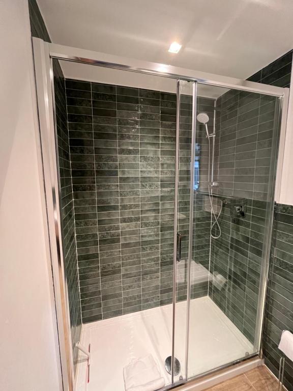 a shower with a glass door in a bathroom at Donna Mariù in Catania