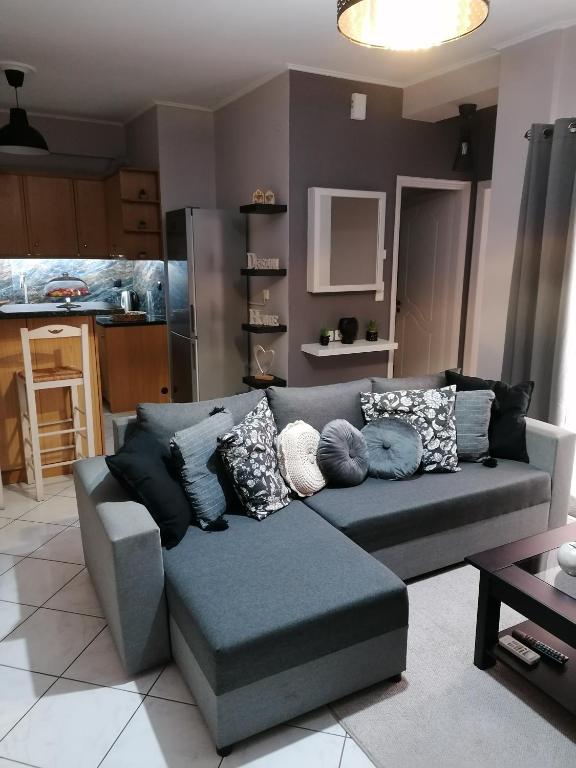 a living room with a gray couch with pillows at ANNA'S HOME Ιωάννινα in Ioannina