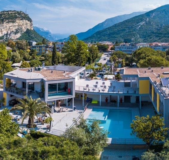 a house with a swimming pool next to a mountain at Camping Al Porto - Mini Glamping & Mobile Homes in Nago-Torbole