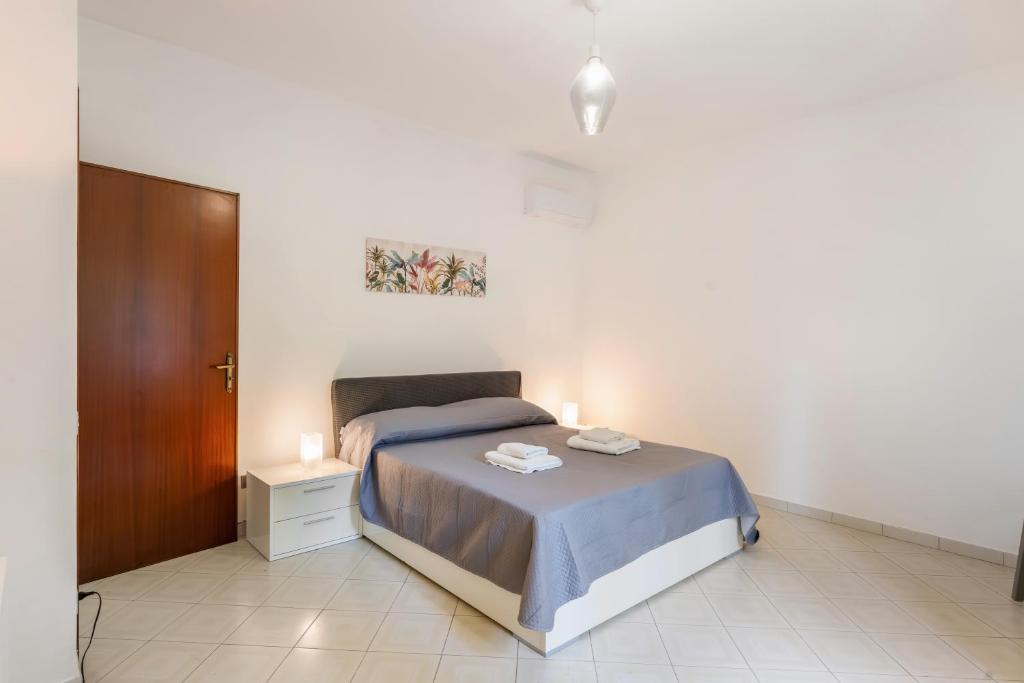 a bedroom with a bed with two candles on it at Casa Nonno Pietro A - Sorrento Coast in Massa Lubrense