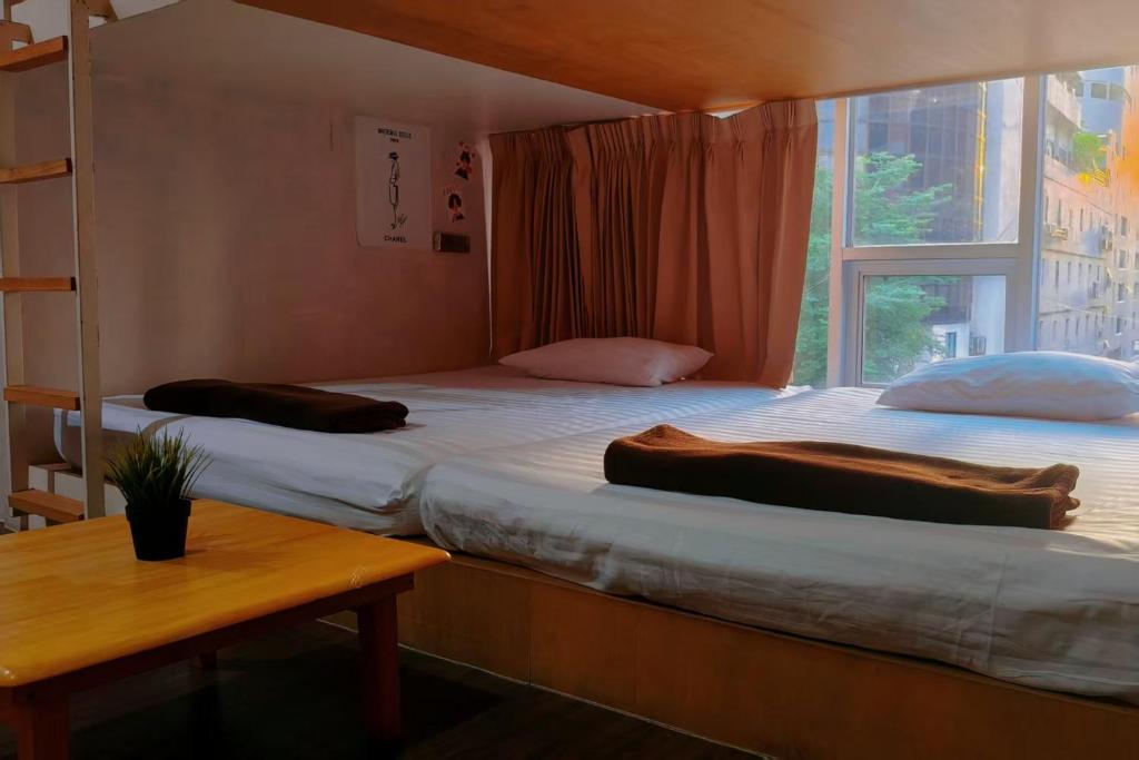 Postel nebo postele na pokoji v ubytování BoB Hostel บ็อบโฮสเทล