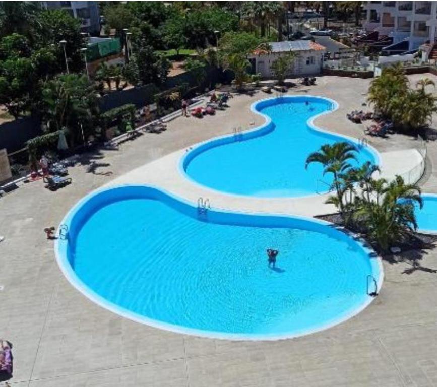 an overhead view of three swimming pools in a resort at Casa Serena in Los Cristianos