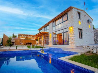 a house with a swimming pool in front of it at villa sunrise in Demre