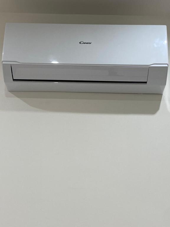 a television sitting on top of a white table at Il Tulipano house in Catania