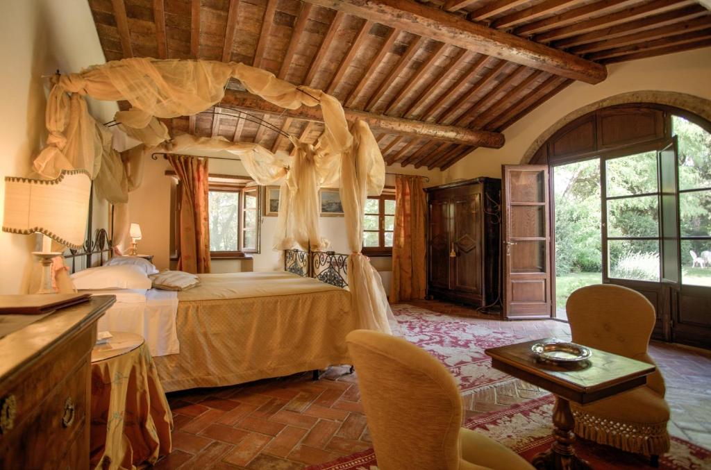 Postel nebo postele na pokoji v ubytování Relais Villa Baldelli