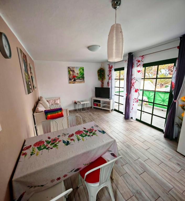 a living room with a table and chairs and a television at La casa di marcos in Costa Calma