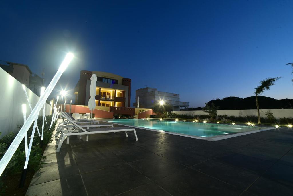 a swimming pool in front of a building at night at Villa Luigia Luxury Relais in Gallipoli