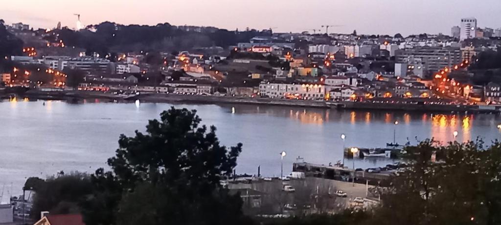 a view of a city with a river at night at Casa MIRA DOURO in Vila Nova de Gaia