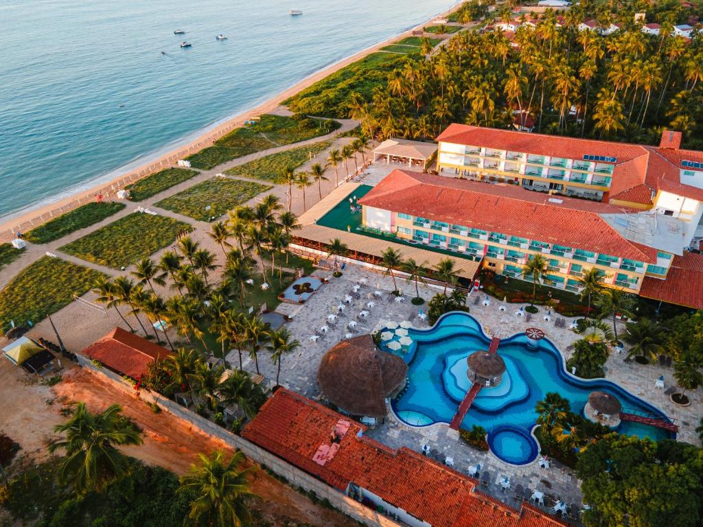 an aerial view of a resort with a swimming pool at Praia Dourada Resort Maragogi in Maragogi