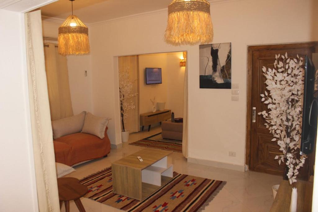 a living room with a couch and a table at The Happy Home in Banī Ghālib