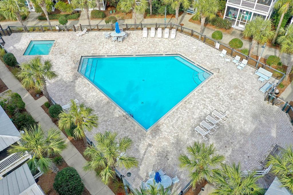 Una vista aérea de una piscina con palmeras. en Barefoot Cottage B12 - Sea La Vie by Pristine Property Vacation Rentals, en Highland View