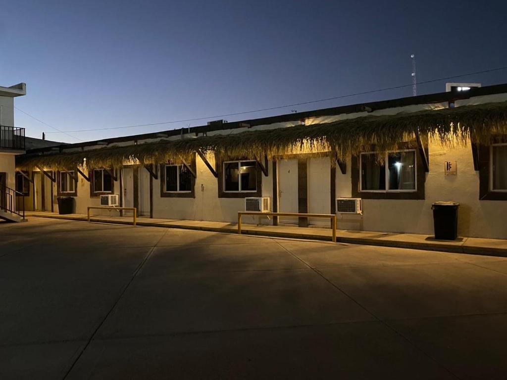 a building with a parking lot in front of it at Rio inn in Delicias