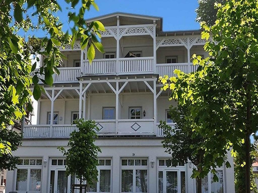 a large white building with a balcony on top of it at Villa Strandblick Binz in Binz