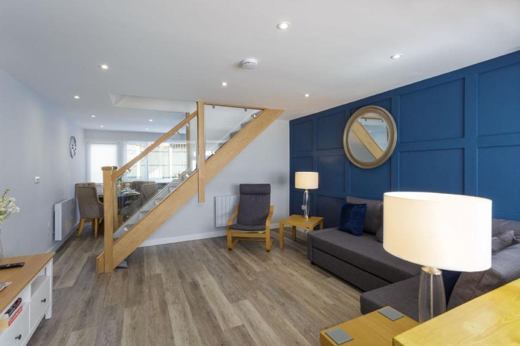 a living room with a couch and a table with a mirror at Castle View - 2 Bed Stylish Coastal Port Solent Retreat with Views! Parking, Sleeps 6 - By Blue Puffin Stays in Portsmouth