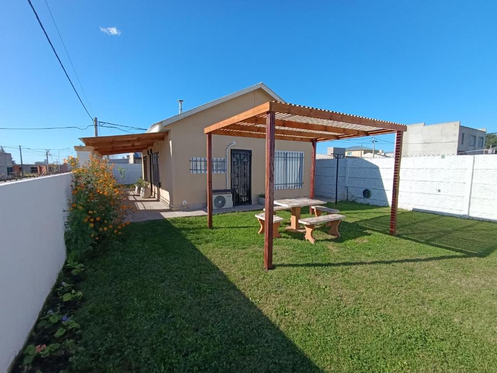a picnic shelter with a picnic table in a yard at Alquiler Temporal Tandil - Xavier in Tandil