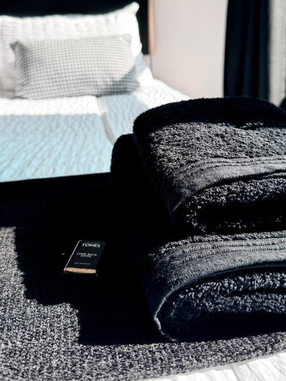 a bedroom with a bed with a black blanket at Cosy Urban Apartment in Durban