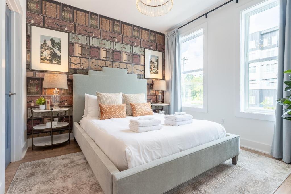 a bedroom with a large white bed with pillows at Chloe at The Lucy by Stay Local Nashville in Nashville
