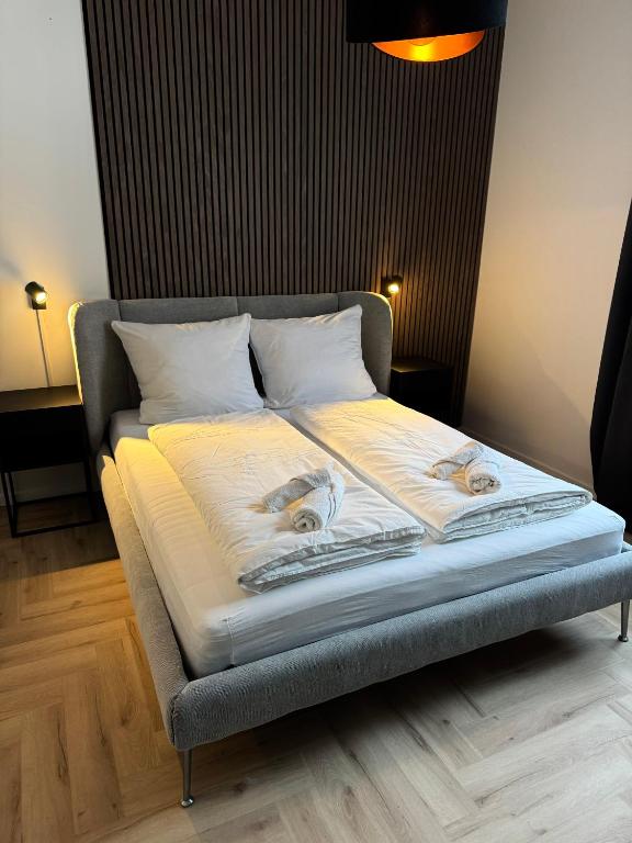 a bed with two people on it in a room at DLG-STAYS Iserlohn in Iserlohn
