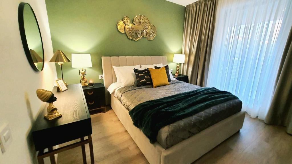 a bedroom with a bed and a mirror on the wall at Aze - Green Business in Bucharest