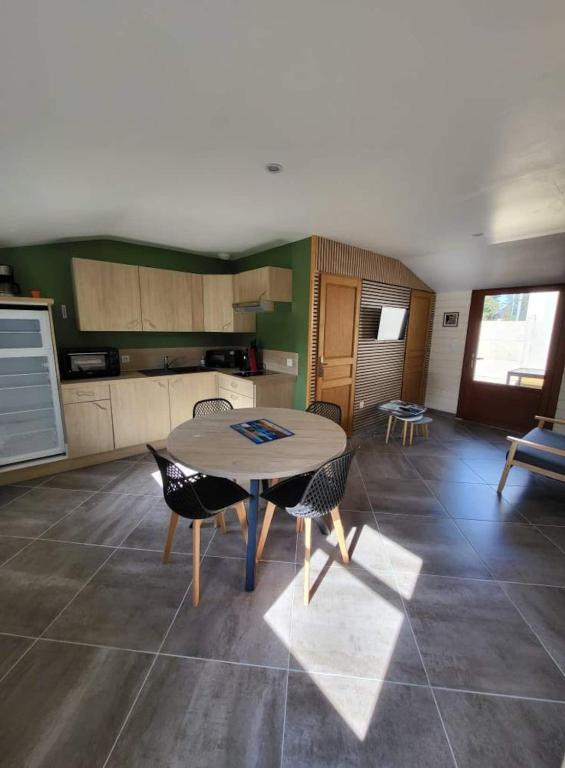 une cuisine et une salle à manger avec une table et des chaises dans l'établissement Le Bikini, à Fort-Mahon-Plage
