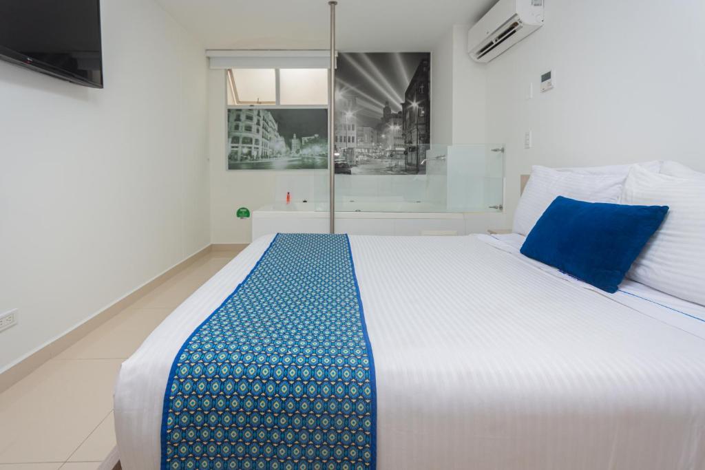 Postel nebo postele na pokoji v ubytování Hotel Laureles Plaza