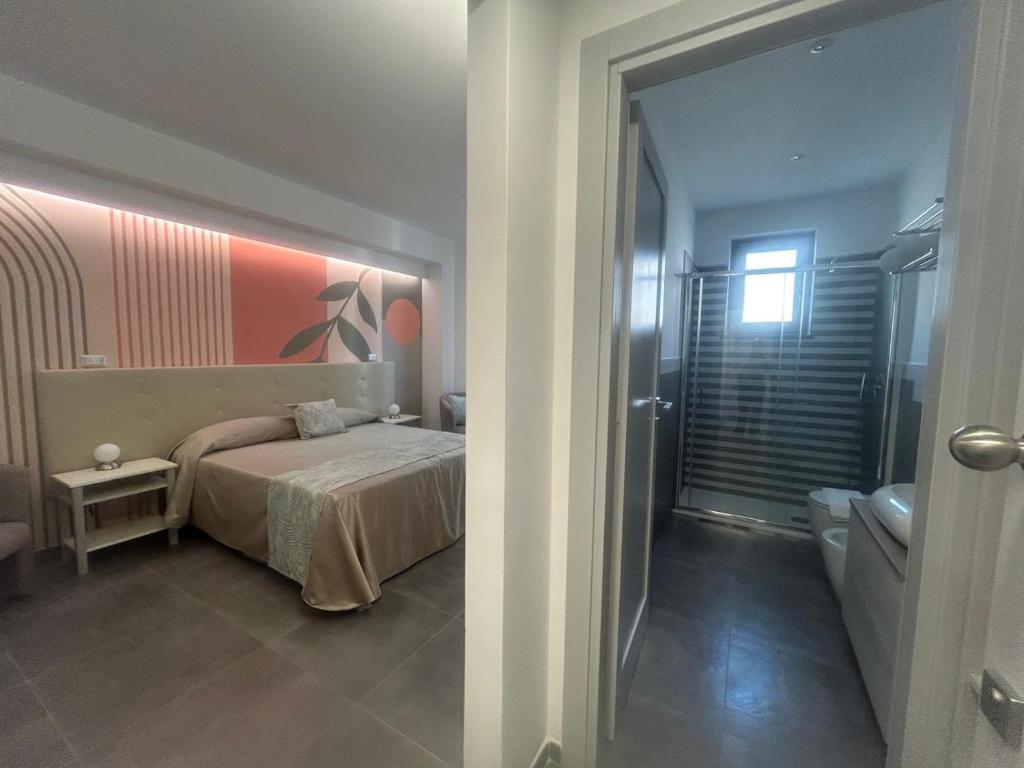 En eller flere senge i et værelse på Eolia Rooms