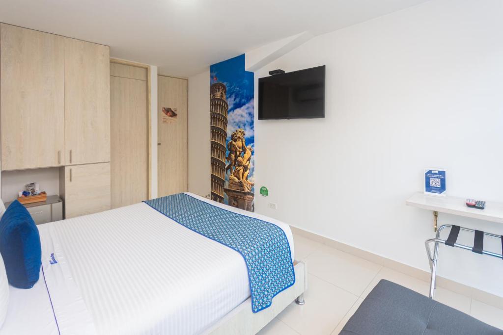 Postel nebo postele na pokoji v ubytování Hotel Laureles Plaza