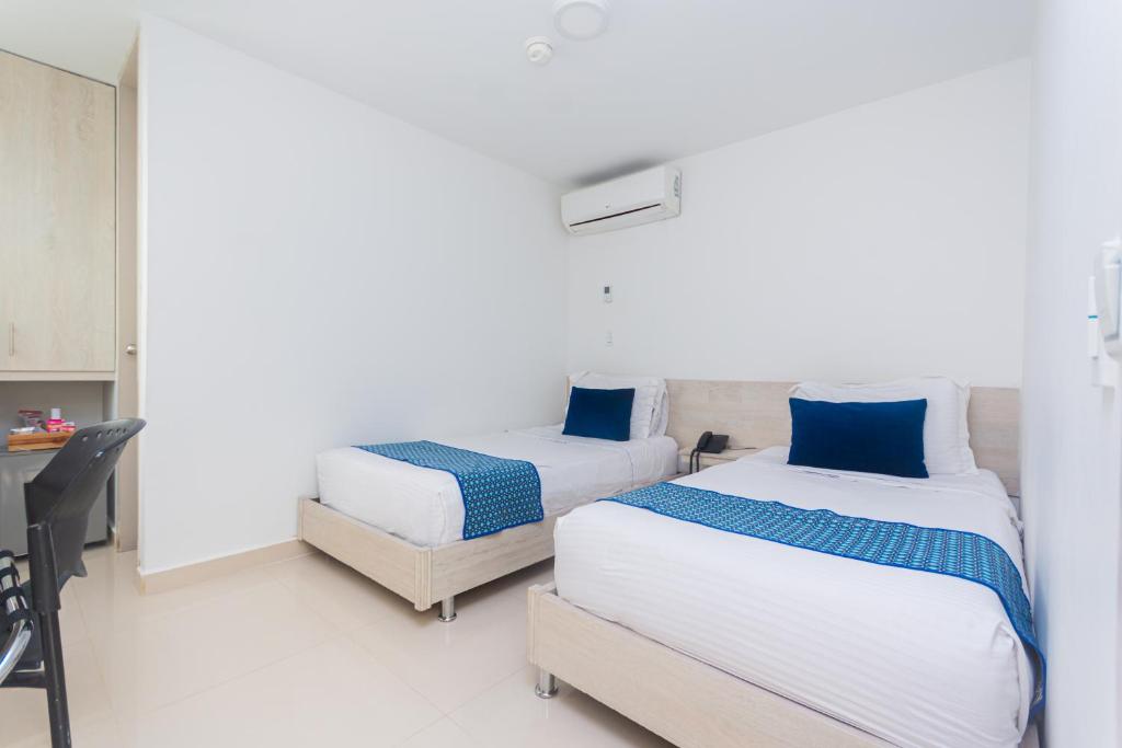 Postel nebo postele na pokoji v ubytování Hotel Laureles Plaza