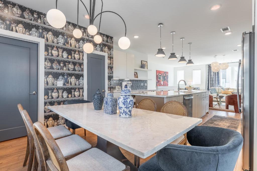 a kitchen and dining room with a table and chairs at Mira at The Lucy by Stay Local Nashville in Nashville