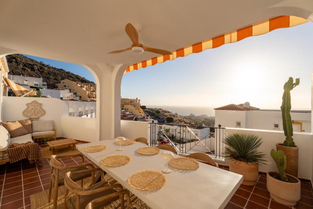 a balcony with a table and chairs with a view at Mosaico Ocean View Boutique Apartment in Adeje
