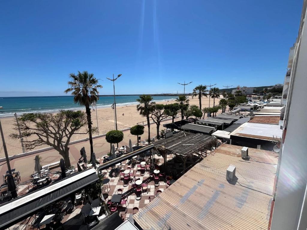 a view of a beach and a street with a crowd of people at Spacious Apartment in Barbate - Terrace with Sea View in Barbate