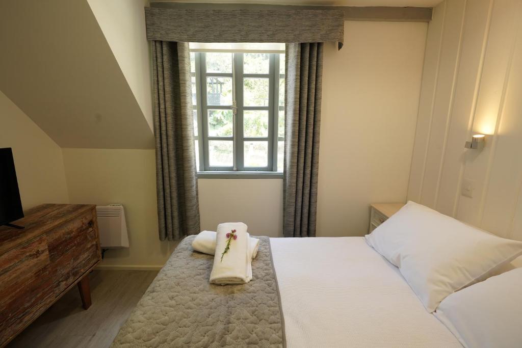 Postel nebo postele na pokoji v ubytování Hotel Frutillar