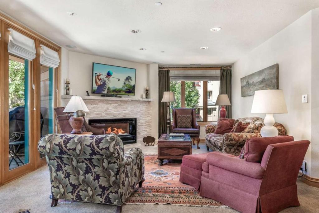 a living room filled with furniture and a fireplace at Ski In, Ski Out 3 Bedroom In Beaver Creek Village With Excellent Mountain Views in Beaver Creek
