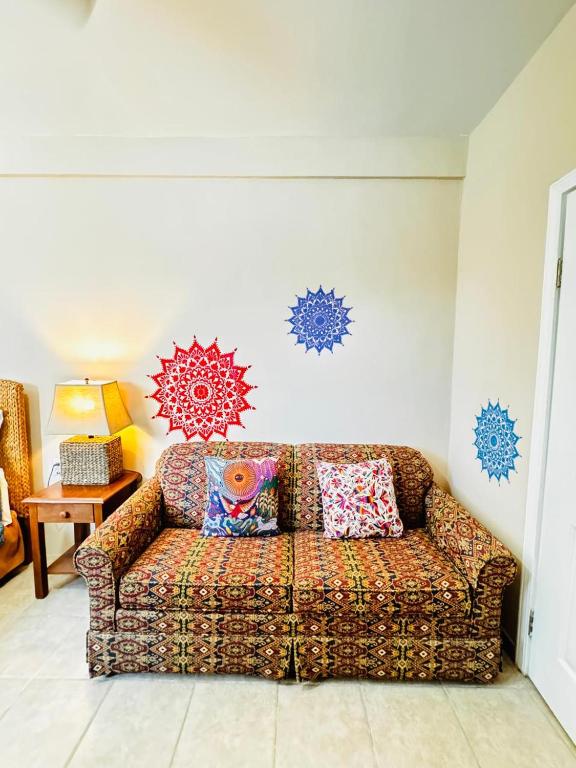 a couch in a living room with blue decorations on the wall at Vaquita Marina House in Puerto Peñasco