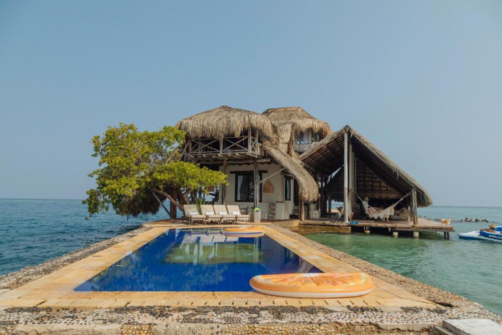a resort with a swimming pool in the water at Isla Kalua - Private Ocean Villa in Isla Pavitos