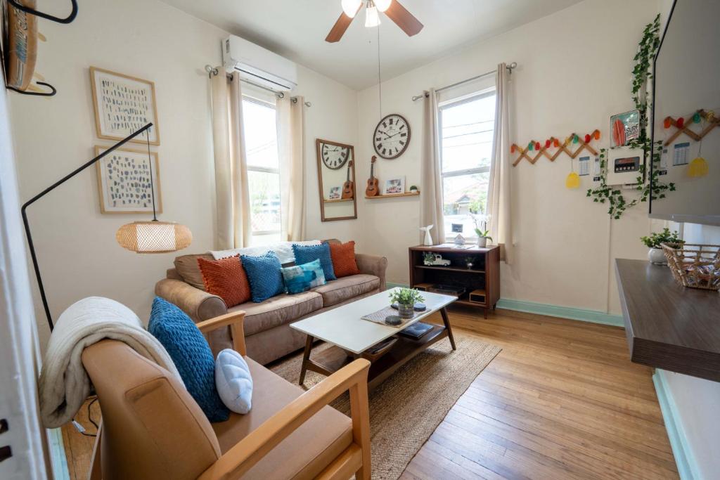 a living room with a couch and a table at Breezy 1BR Retreat Walk to UofA and Spring Fun in Tucson