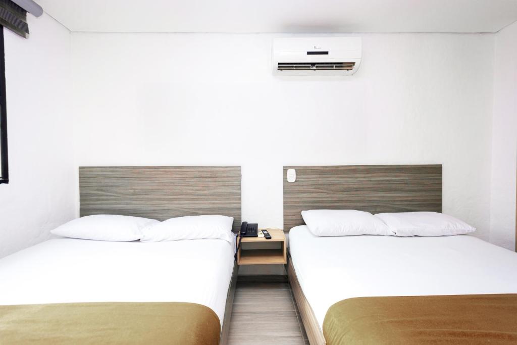 Postel nebo postele na pokoji v ubytování Novus Laureles