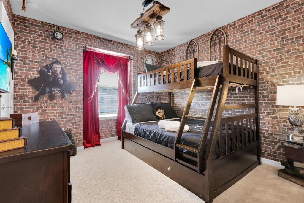 a bedroom with a brick wall and a bunk bed at Exceptional House 5BD4.5BA Private Pool WW8907 in Kissimmee